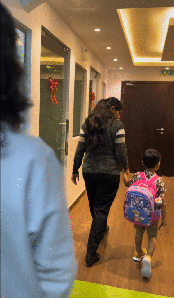 Child with a backpack walking hand-in-hand with a caregiver at the best special education center Dubai, showing a nurturing and secure environment.